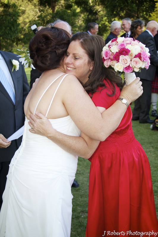Sister congratulating bride - wedding photography sydney